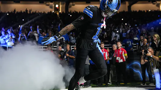 Jameson Williams - who's featured in our anytime TD predictions for Week 9 - runs onto the field.