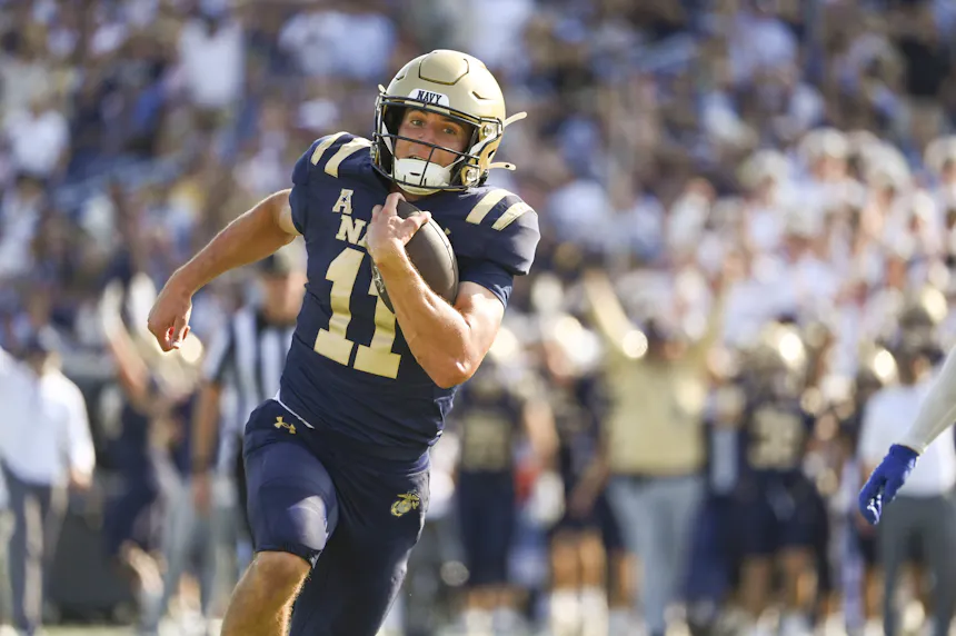 Navy Midshipmen quarterback Blake Horvath rushes for a first-quarter touchdown against the Memphis Tigers as we look at our Navy vs. Air Force Prediction.