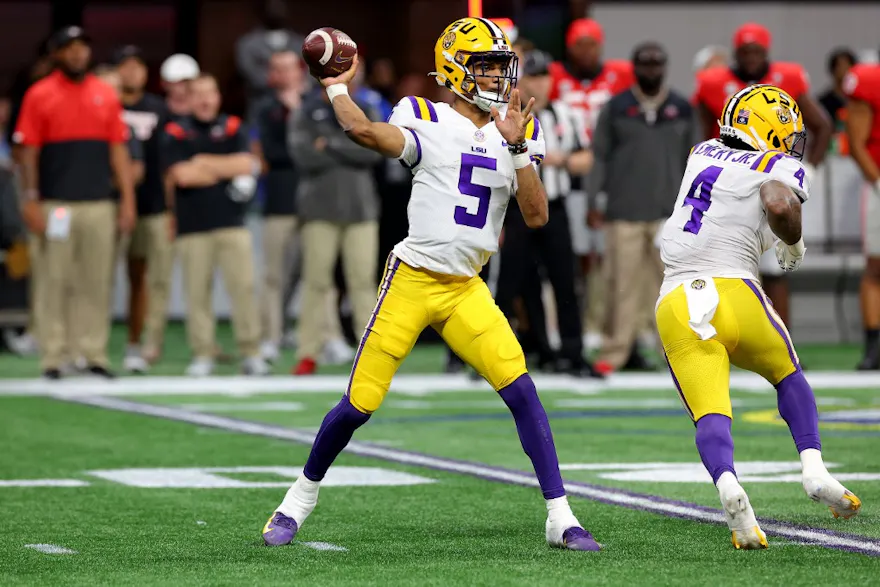 Jayden Daniels of the LSU Tigers looks to pass against the Georgia Bulldogs.
