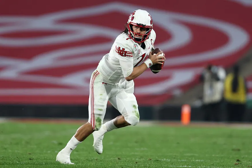 Cameron Rising of the Utah Utes rolls out during the first half of the Rose Bowl game against the Ohio State Buckeyes.