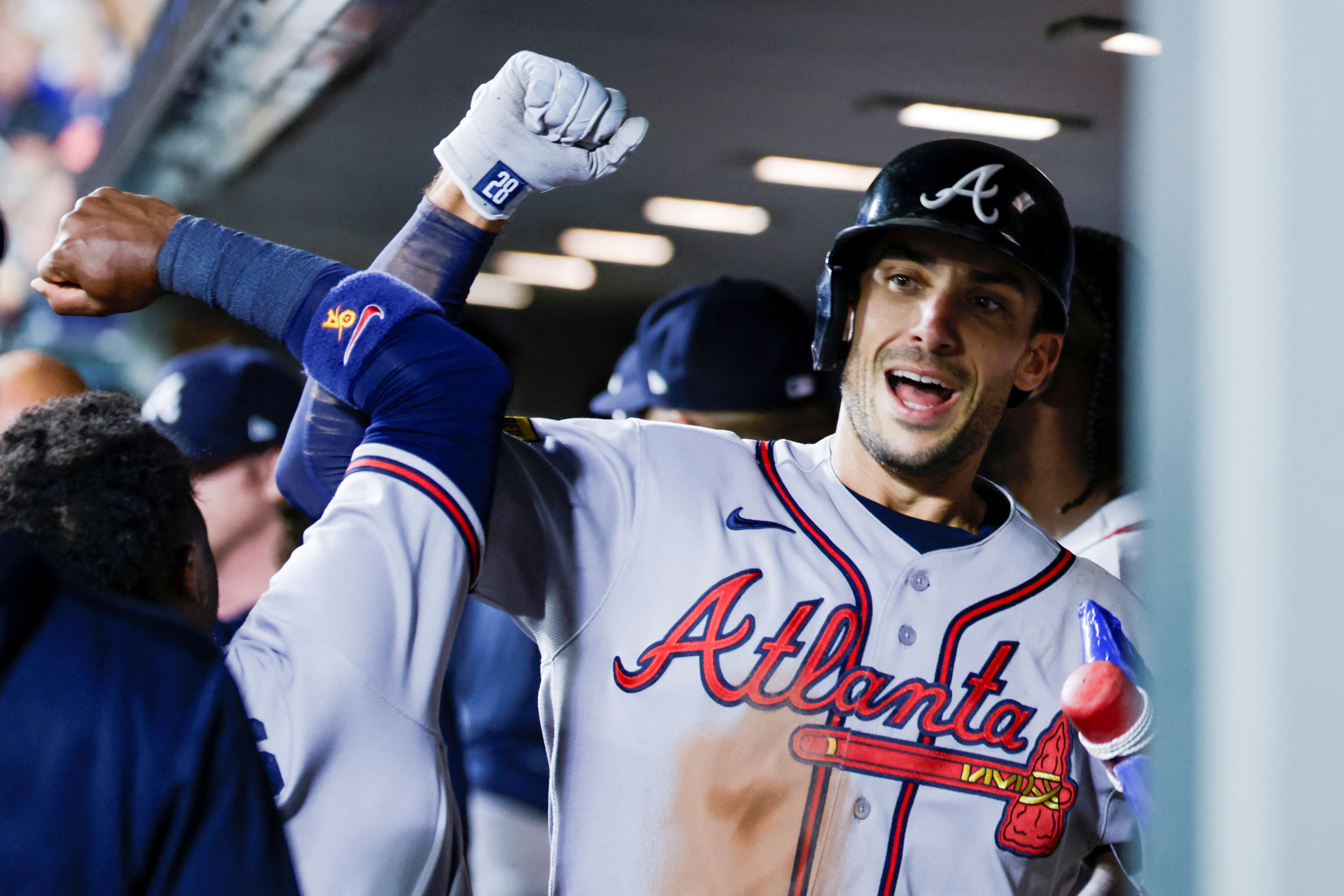 Atlanta Braves first baseman Matt Olson bumps forearms with a teammate in the dugout after hitting a solo home run, and he's featured as part of my home run predictions today.