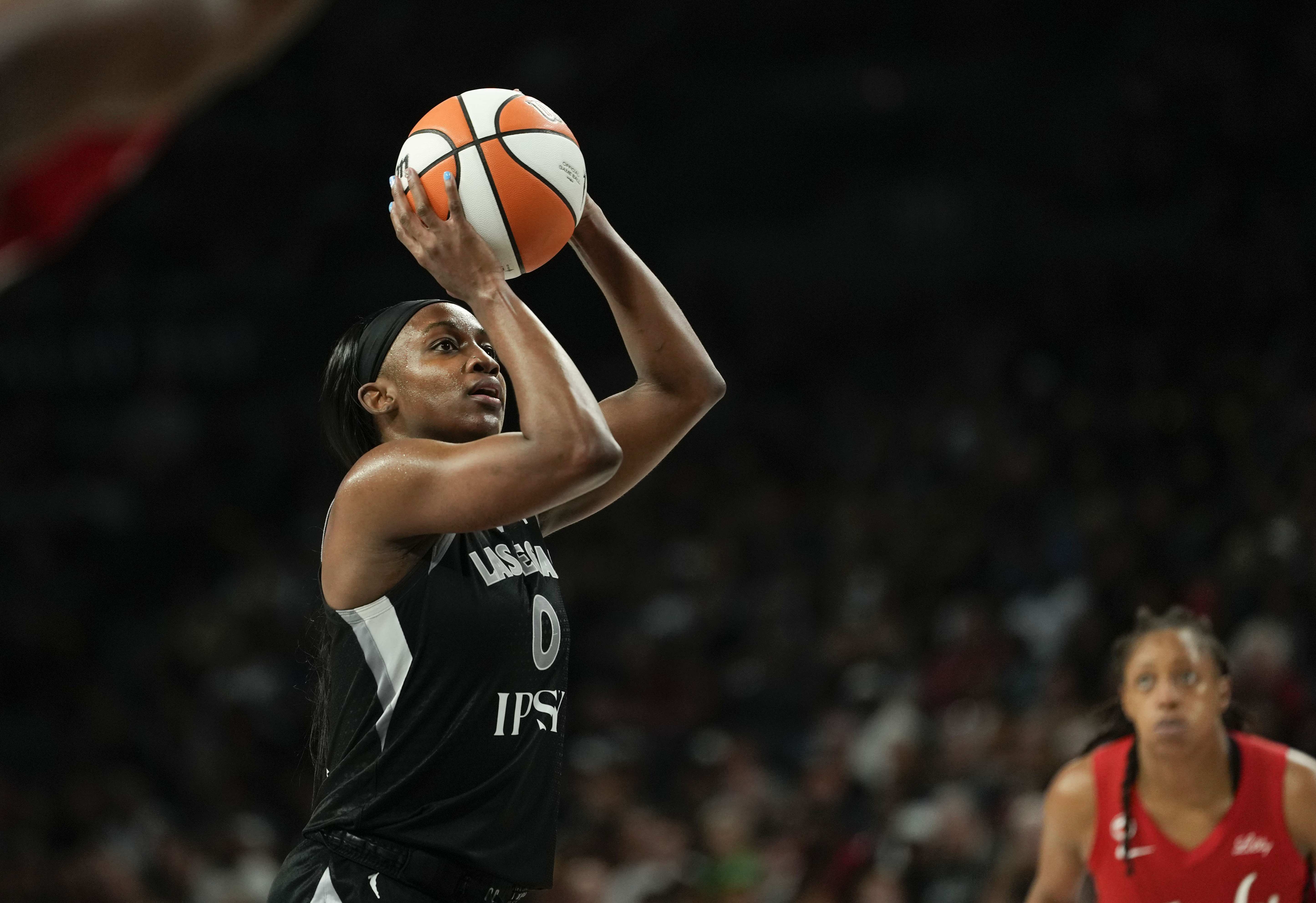 Las Vegas Aces guard Jackie Young (0) shoots a free throw as she is featured in our Aces vs. Valkyries prediction.