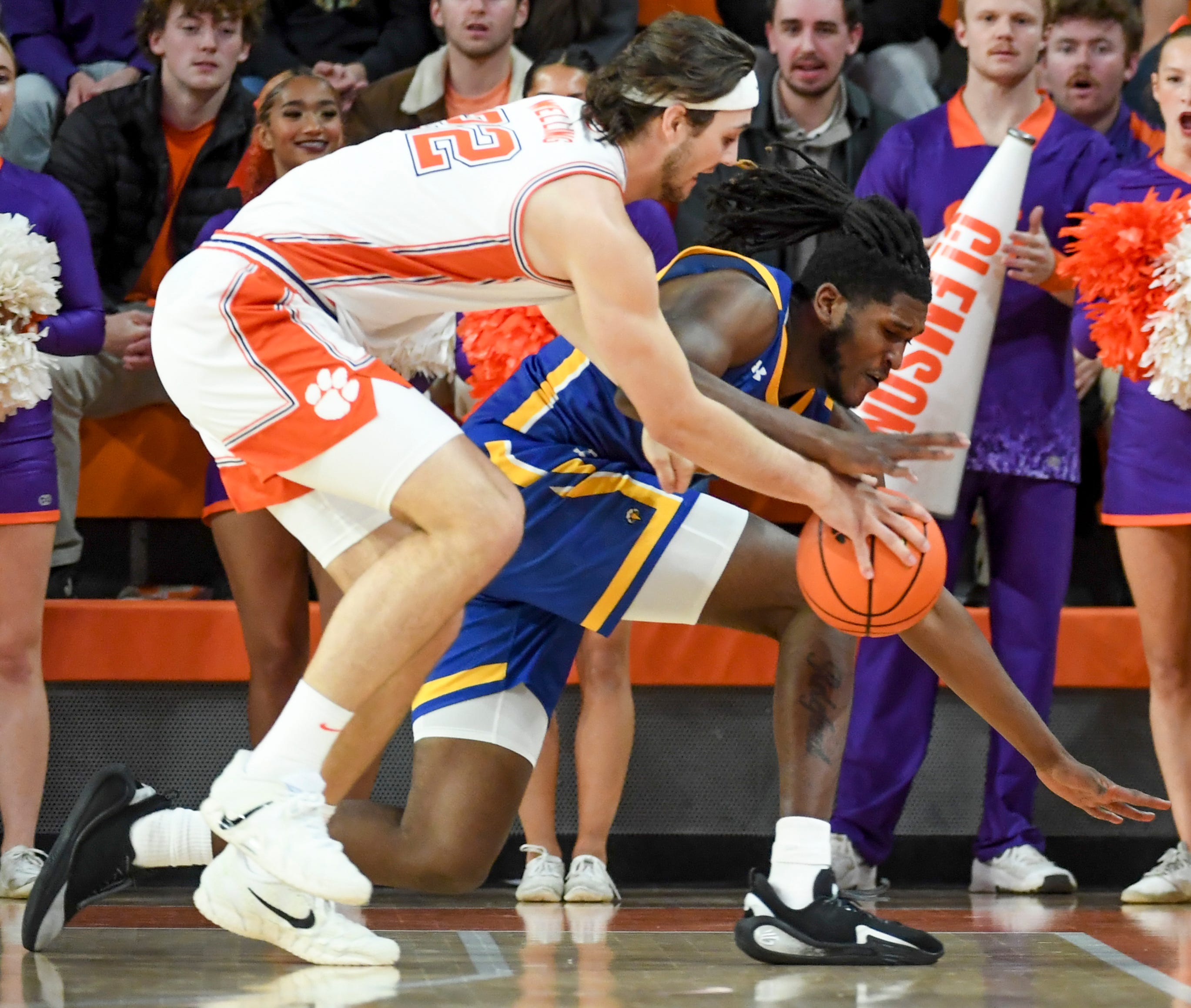 Clemson Tigers center Carter Welling and Morehead State Eagles center Tamaury Releford (24) go for a loose ball as we offer our Clemson vs. Georgia prediction.