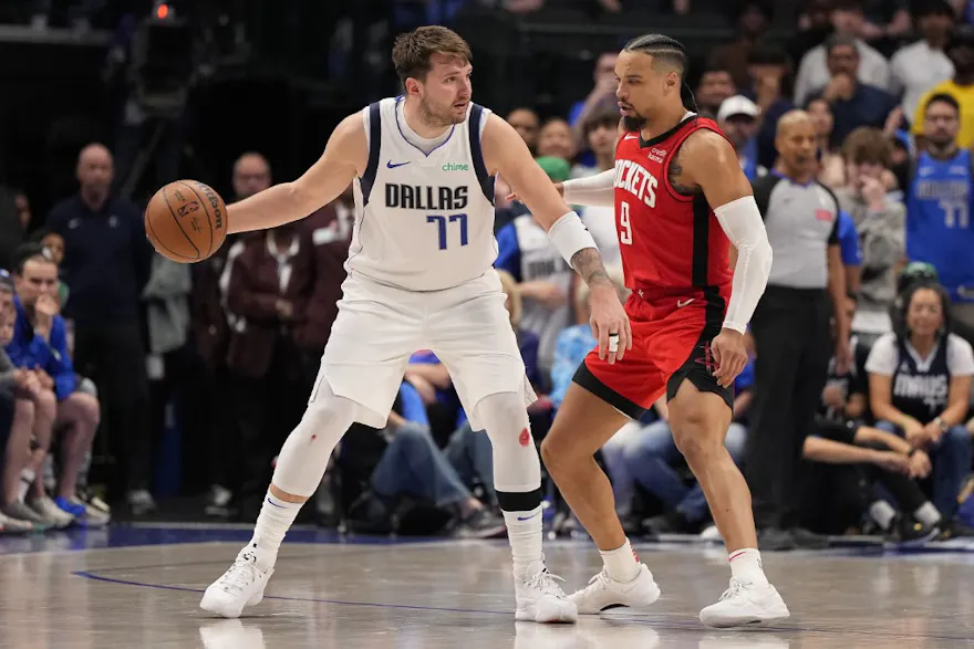 Luka Doncic of the Dallas Mavericks is defended by Dillon Brooks of the Houston Rockets during overtime at American Airlines Center. We're backing Doncic in our Mavericks vs. Heat player prop prediction. 