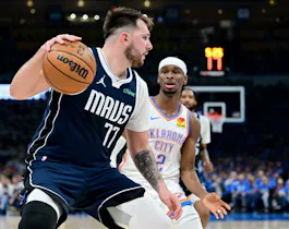 Luka Doncic (77) of the Dallas Mavericks drives against Shai Gilgeous-Alexander (2) of the Oklahoma City Thunder, as we offer our best Mavericks vs. Thunder player props for Game 2 on Thursday at Paycom Center in Oklahoma City.