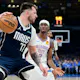 Luka Doncic (77) of the Dallas Mavericks drives against Shai Gilgeous-Alexander (2) of the Oklahoma City Thunder, as we offer our best Mavericks vs. Thunder player props for Game 2 on Thursday at Paycom Center in Oklahoma City.