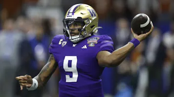 Michael Penix Jr. of the Washington Huskies throws a pass during the fourth quarter against the Texas Longhorns during the CFP Semifinal Allstate Sugar Bowl as we look at our bet365 promo code for Washington-Michigan.