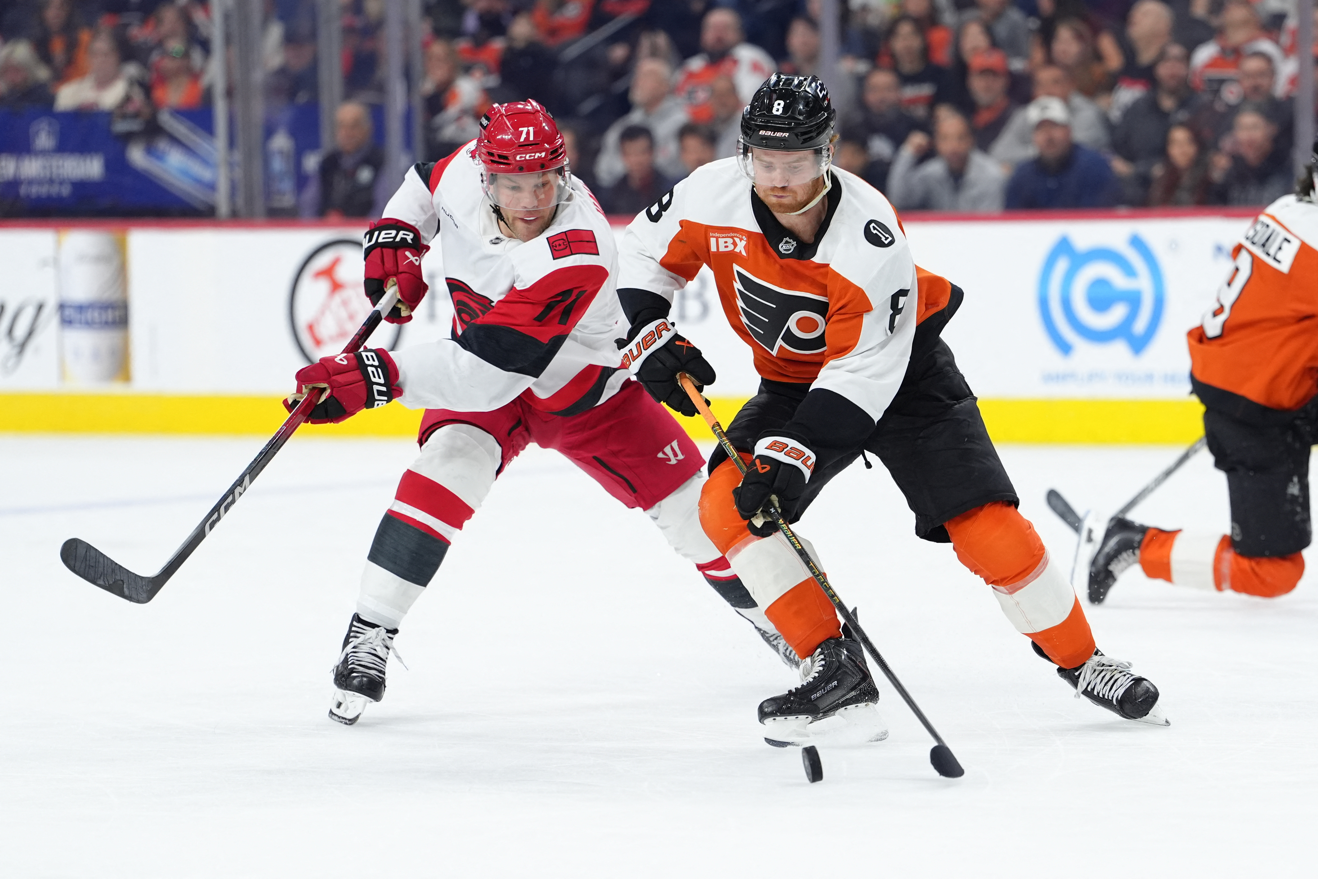 Philadelphia Flyers defenseman Cam York (8) reaches for the puck against Carolina Hurricanes left wing Taylor Hall (71) as we provide our Flyers vs. Hurricanes Game 1 prediction.