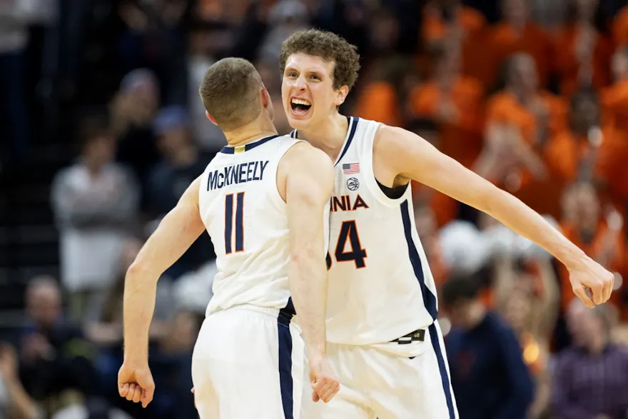 Jake Groves #34 and Isaac McKneely #11 of the Virginia Cavaliers celebrate a shot as we look at the Virginia sports betting handle for December 2023.