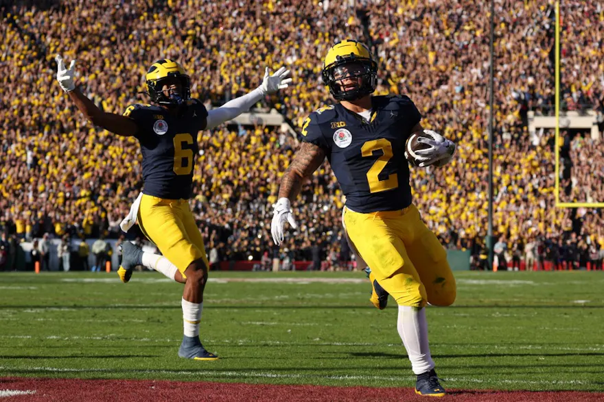 Blake Corum #2 of the Michigan Wolverines scores a touchdown as we make our Washington vs. Michigan expert picks for the College Football Playoff National Championship Game on Monday at NRG Stadium in Houston.