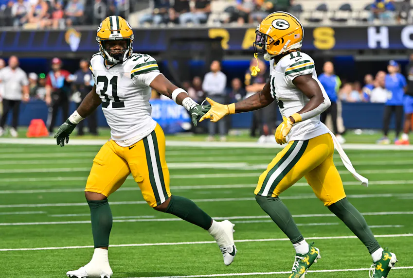 Green Bay Packers wide receiver Jayden Reed celebrates a long gain with teammate running back Emanuel Wilson as we offer our NFL best bets for Week 6.