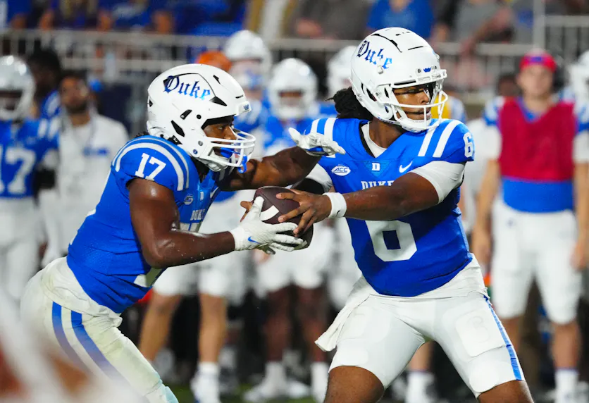 Duke quarterback Maalik Murphy hands the ball off to running back Star Thomas against Elon. We're backing the Blue Devils to cover in our Duke vs. Northwestern prediction.