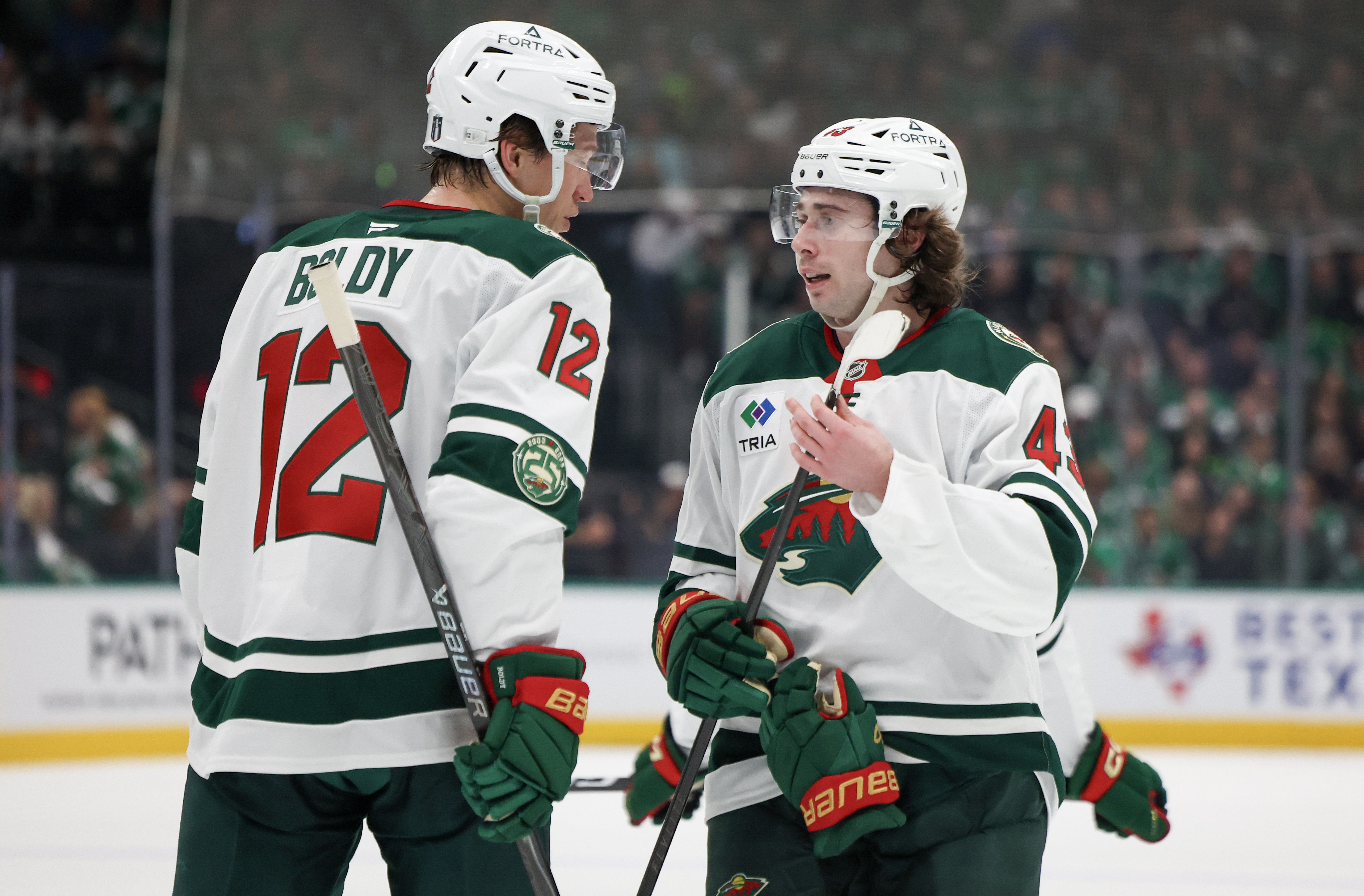 Minnesota Wild left wing Matt Boldy (12) talks to defenseman Quinn Hughes - who's featured in my Wild vs. Stars prediction - during a stoppage. 