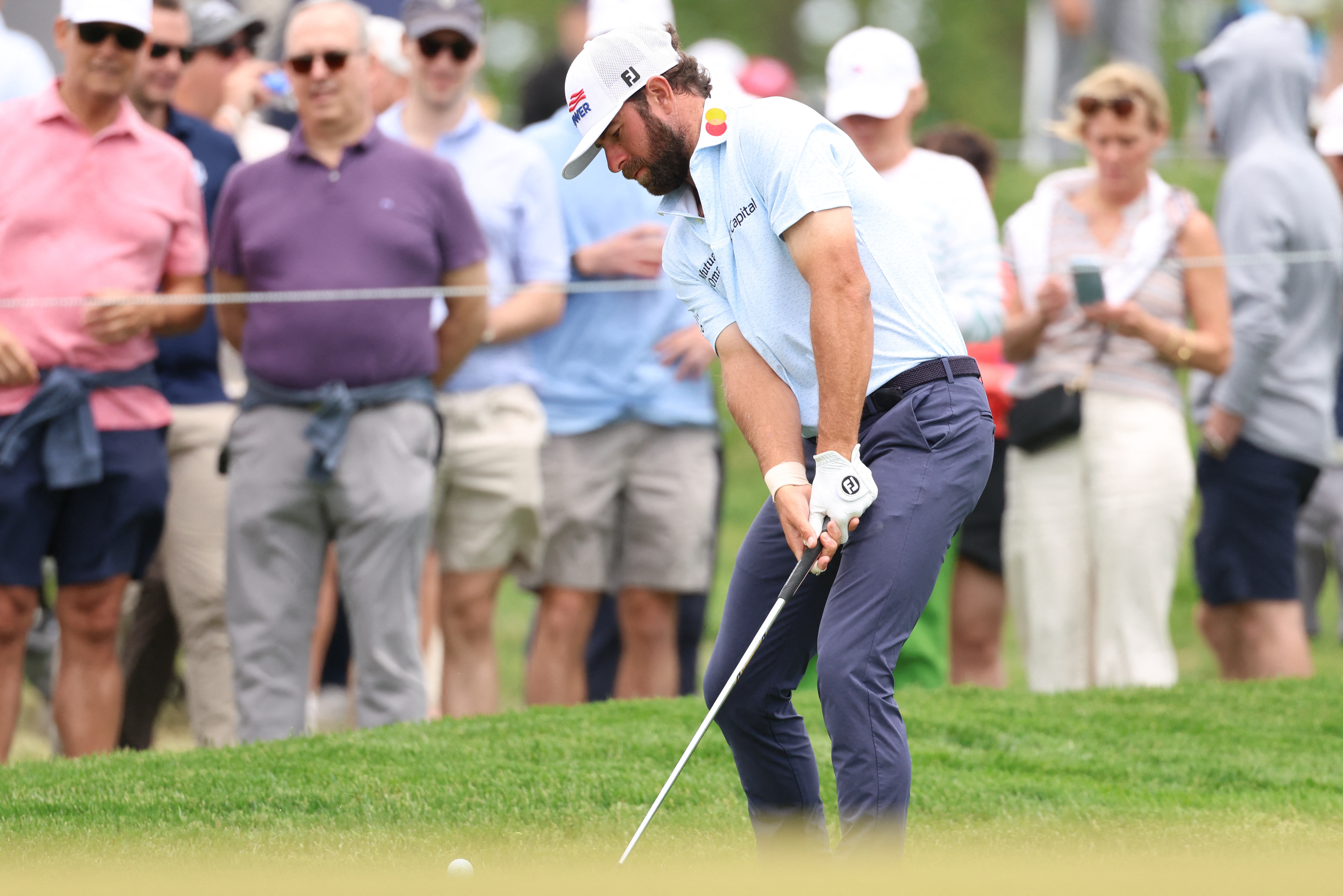 Cameron Young chips on the seventh hole during a practice round of the PGA Championship golf tournament at Aronimink Golf Club. 