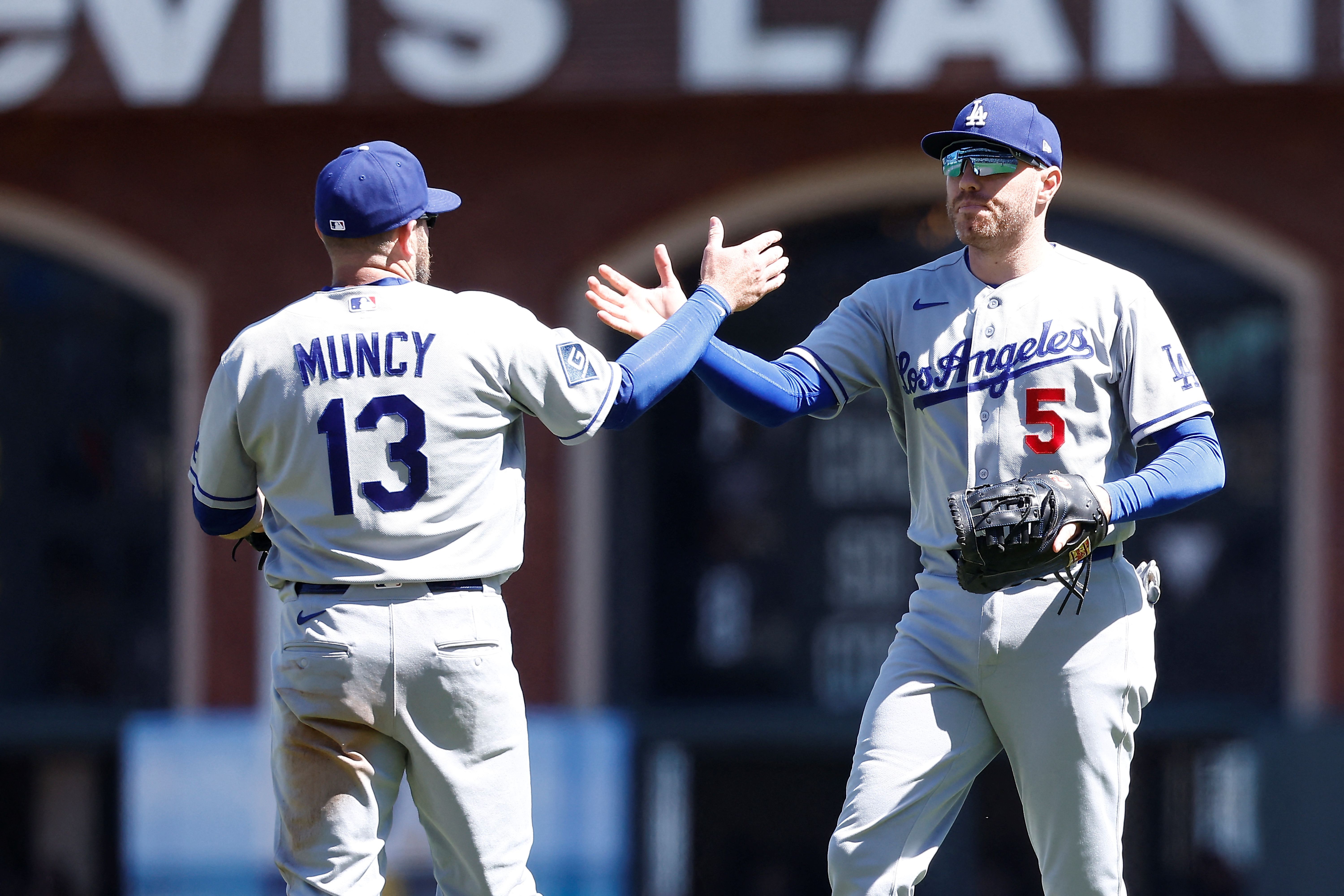 Los Angeles Dodgers third baseman Max Muncy celebrates with first baseman Freddie Freeman, and the latter is key to my home run predictions today.