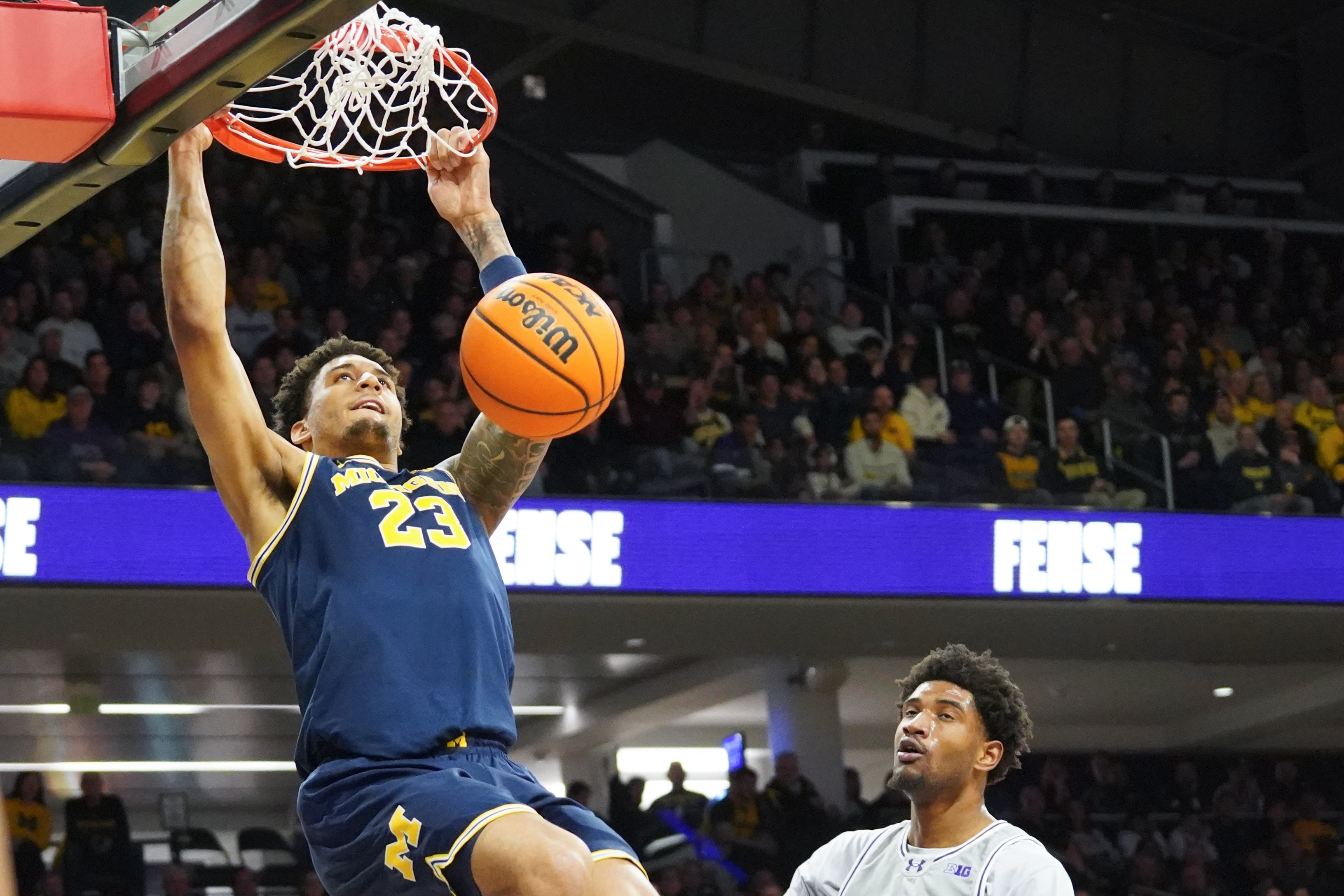 Michigan Wolverines forward Yaxel Lendeborg (23) dunks the ball as we break down our Michigan vs. Duke prediction & odds.