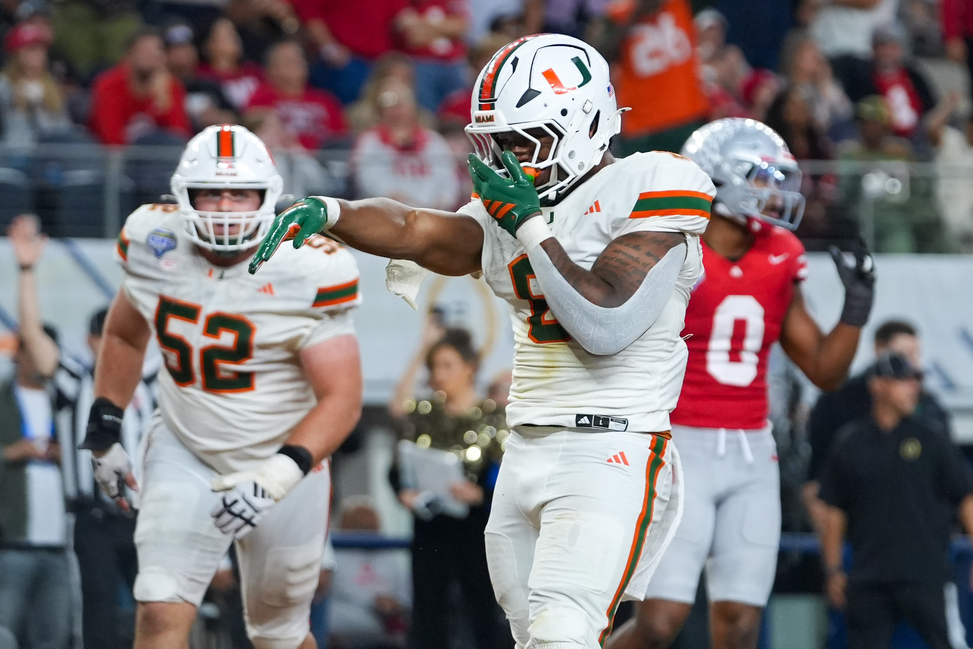 Miami Hurricanes running back Charmar Brown reacts after scoring a touchdown as we offer our best Miami vs. Ole Miss prediction and early picks
