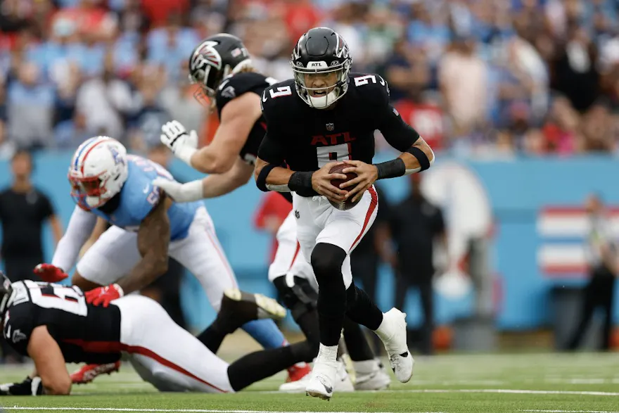 Desmond Ridder of the Atlanta Falcons runs with the ball as part of our Week 12 NFL predictions for Saints vs. Falcons