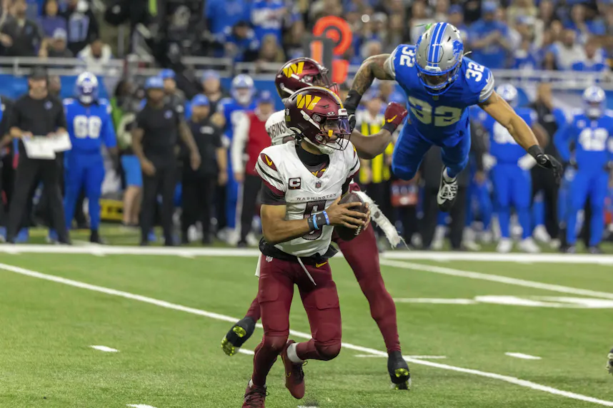 Washington Commanders quarterback Jayden Daniels as Detroit Lions defensive back Brian Branch blitzes. We're looking at Jayden Daniels odds, player props for the NFC Championship Game.