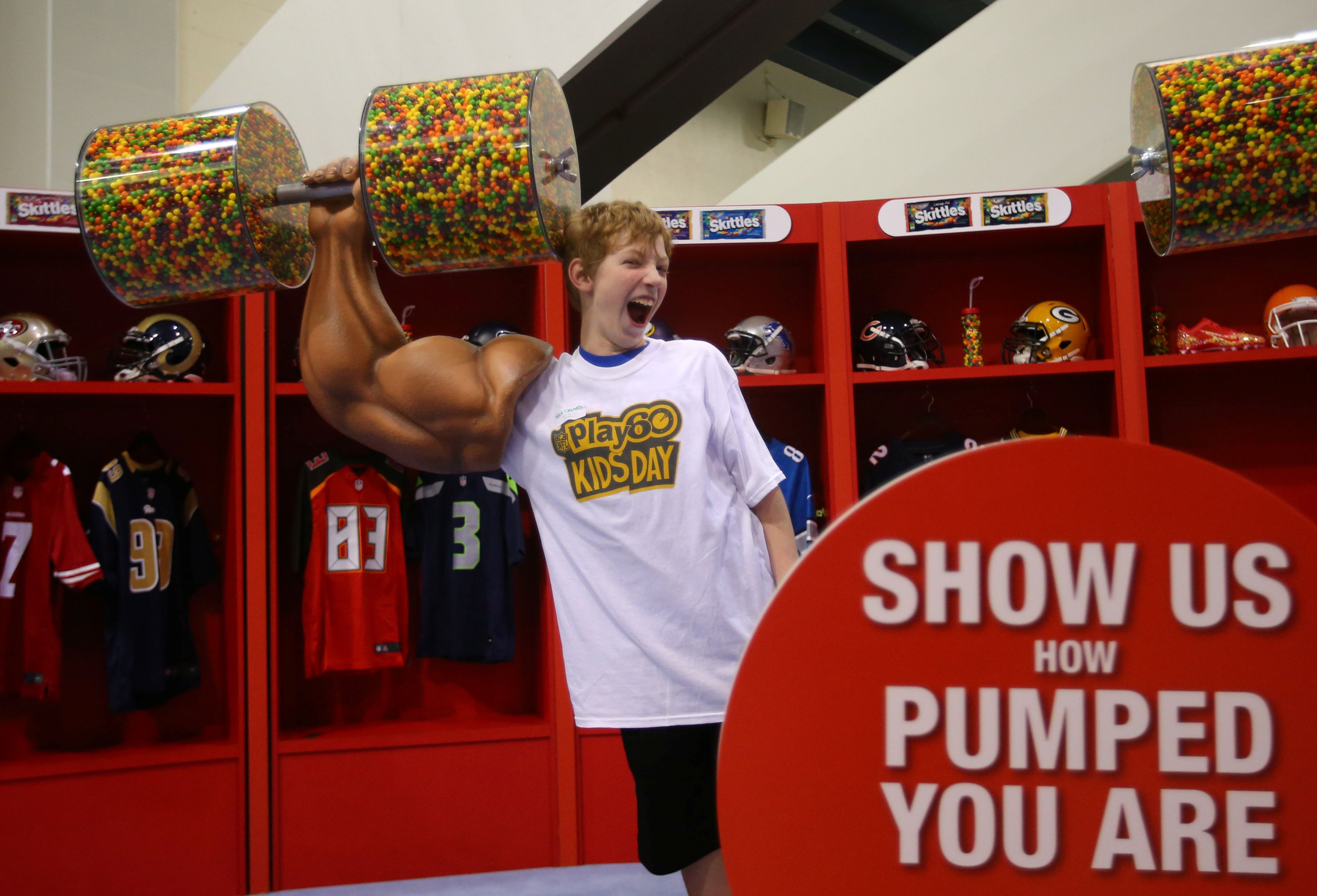 A youngster poses with the Skittles display during NFL Play 60 kids day as we look at the Super Bowl 2026 parental survival kit