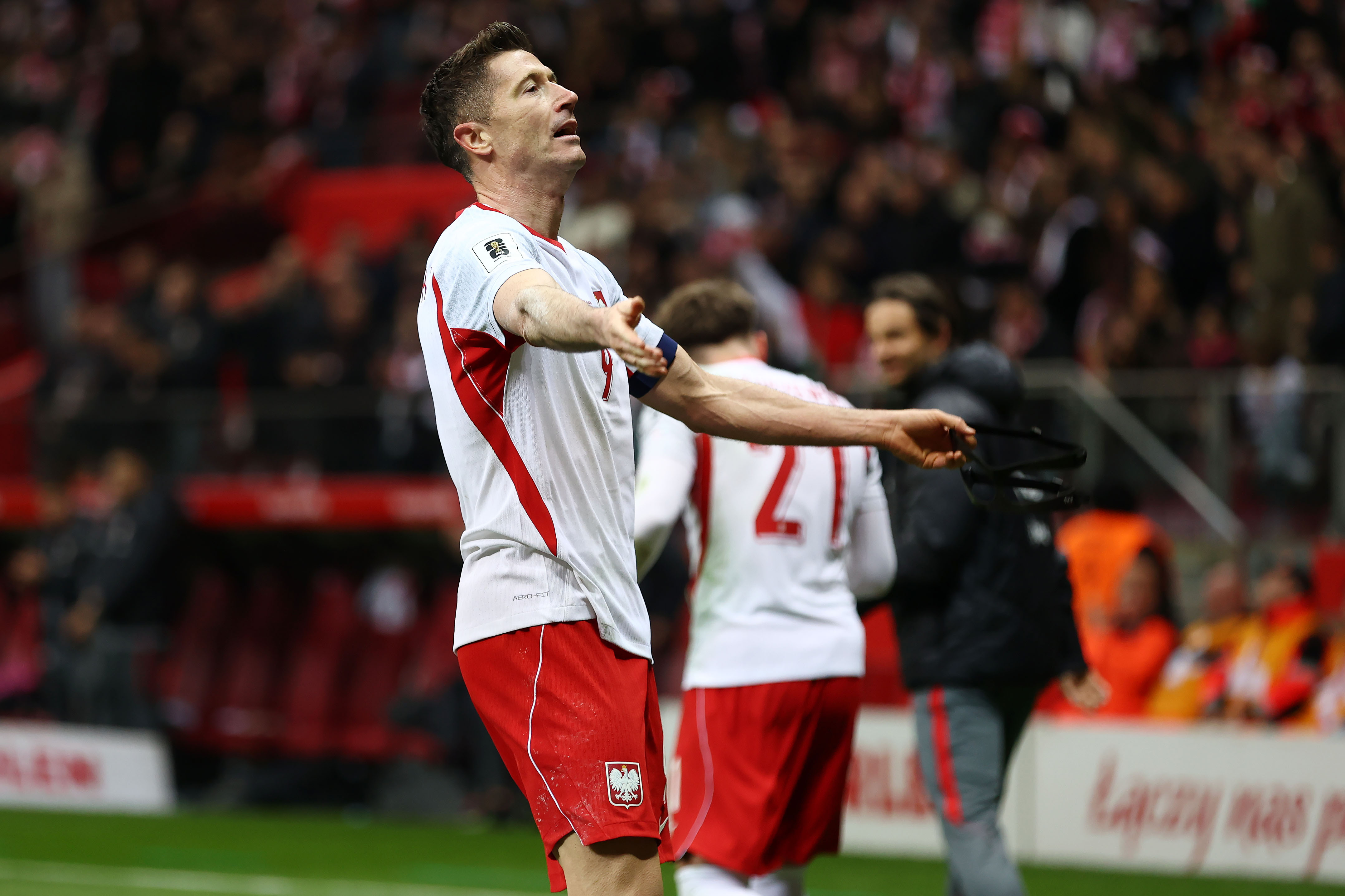 Robert Lewandowski celebrates scoring a goal as we provide our Sweden vs. Poland prediction and odds for the playoff final.