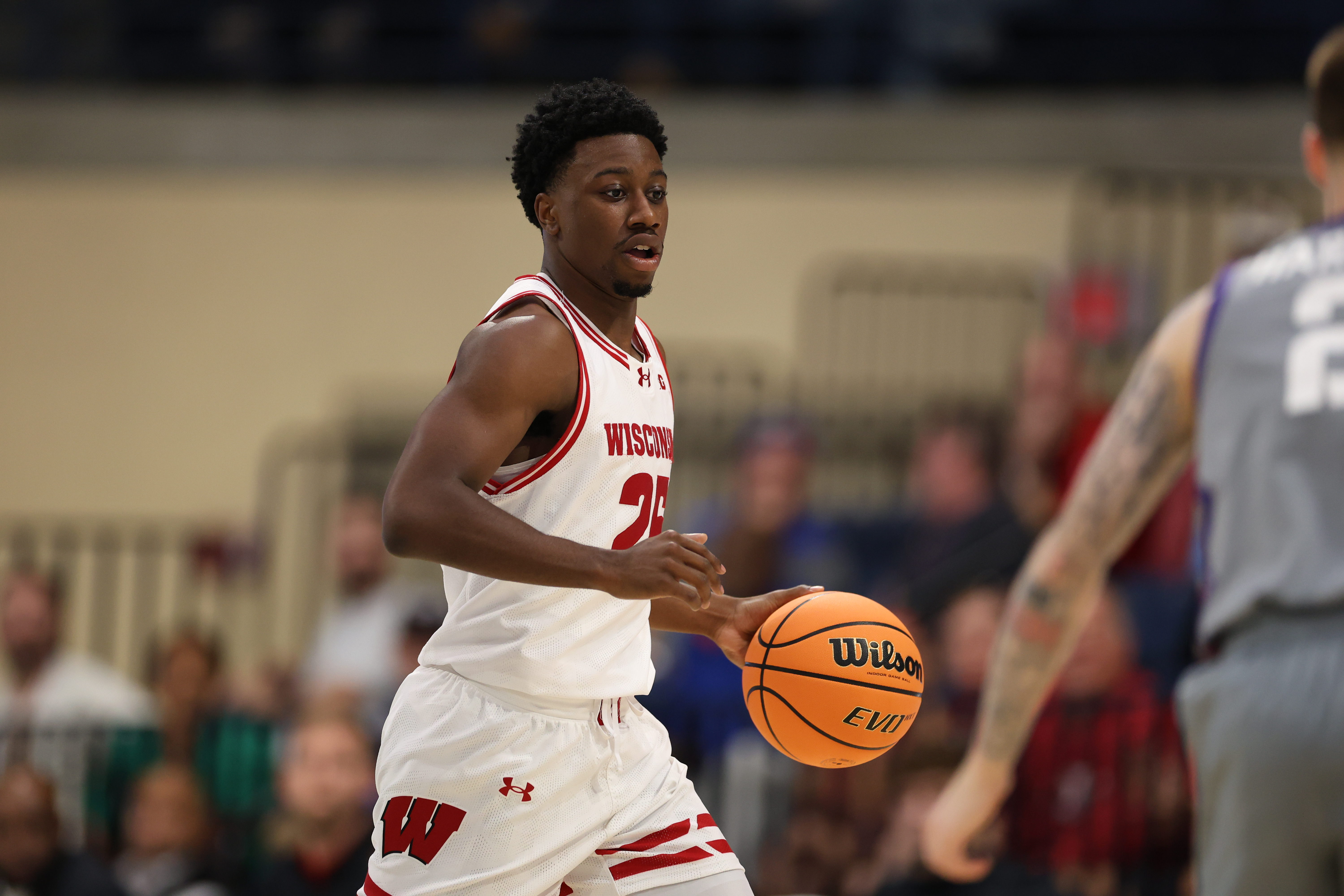 Wisconsin Badgers guard John Blackwell (25), seen here handling the ball, is featured in our college basketball best bets tonight.