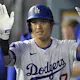 Shohei Ohtani #17 of the Los Angeles Dodgers is congratulated in the dugout after hitting a solo home run as we make our best Padres vs. Dodgers Sunday Night Baseball prop picks and predictions.  