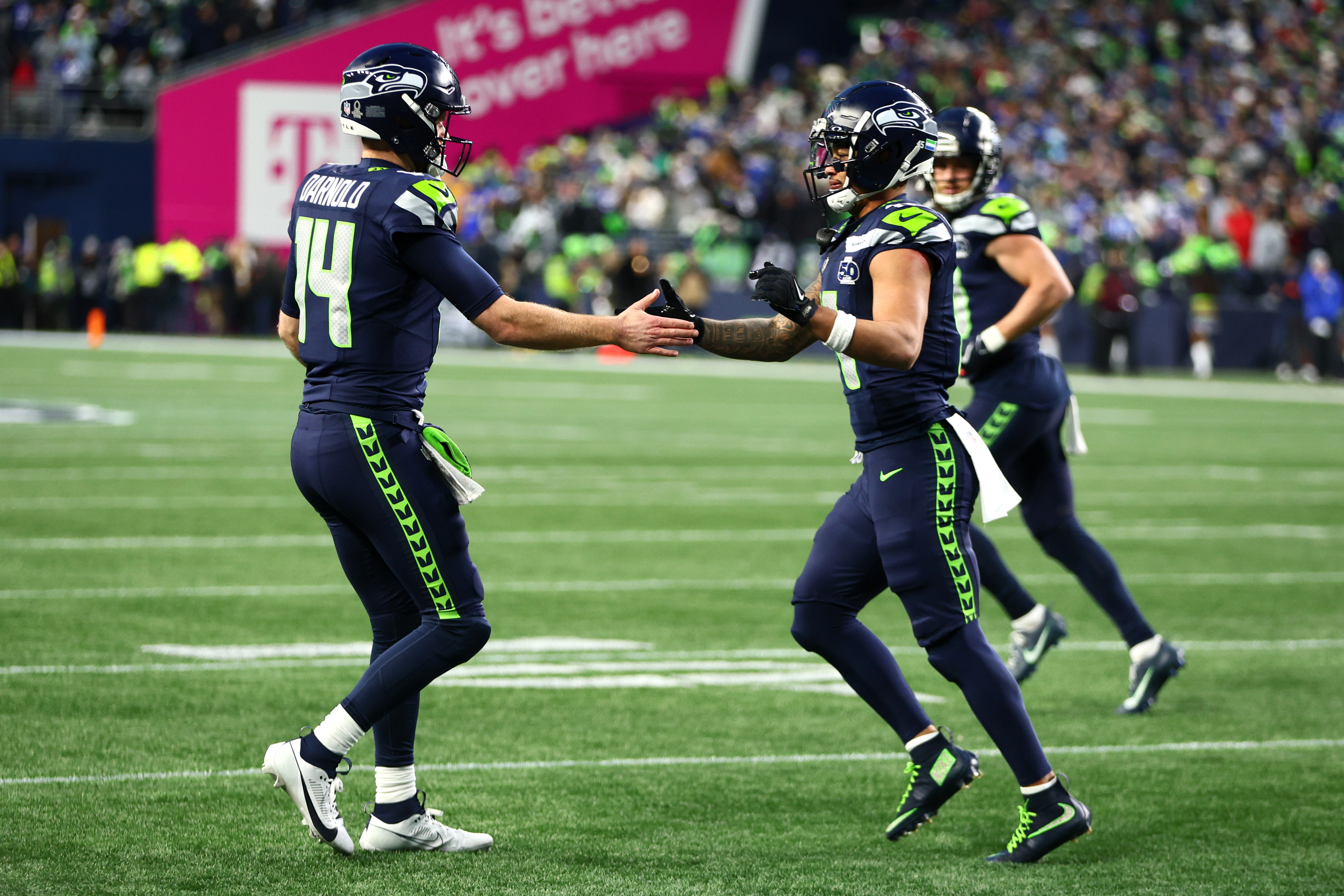 Jaxon Smith-Njigba celebrates with quarterback Sam Darnold after scoring a touchdown as we provide our Seahawks vs. Patriots prediction for Super Bowl 2026. 