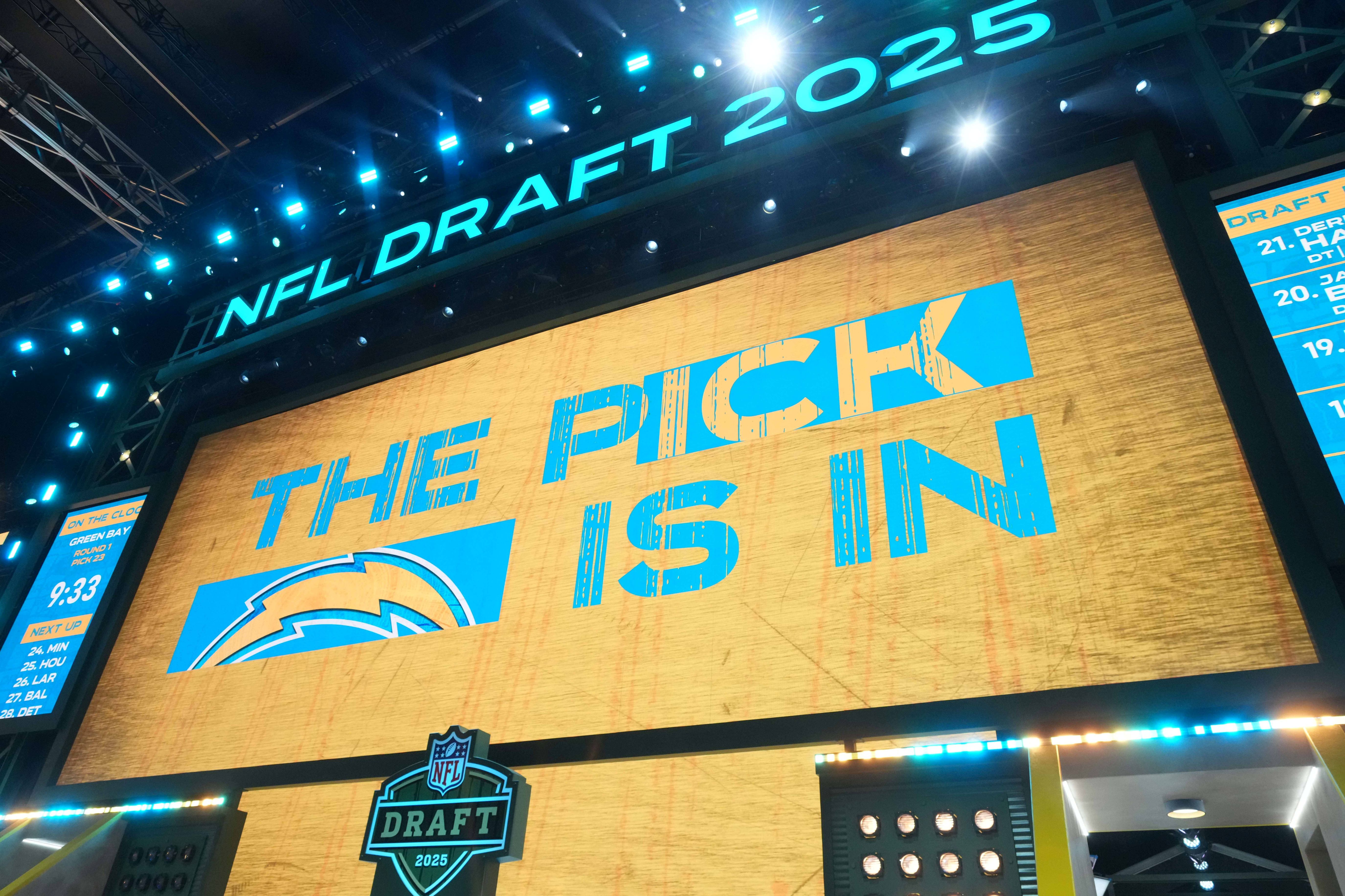 The Los Angeles Chargers logo is projected on the video board during the NFL Draft at Lambeau Field.