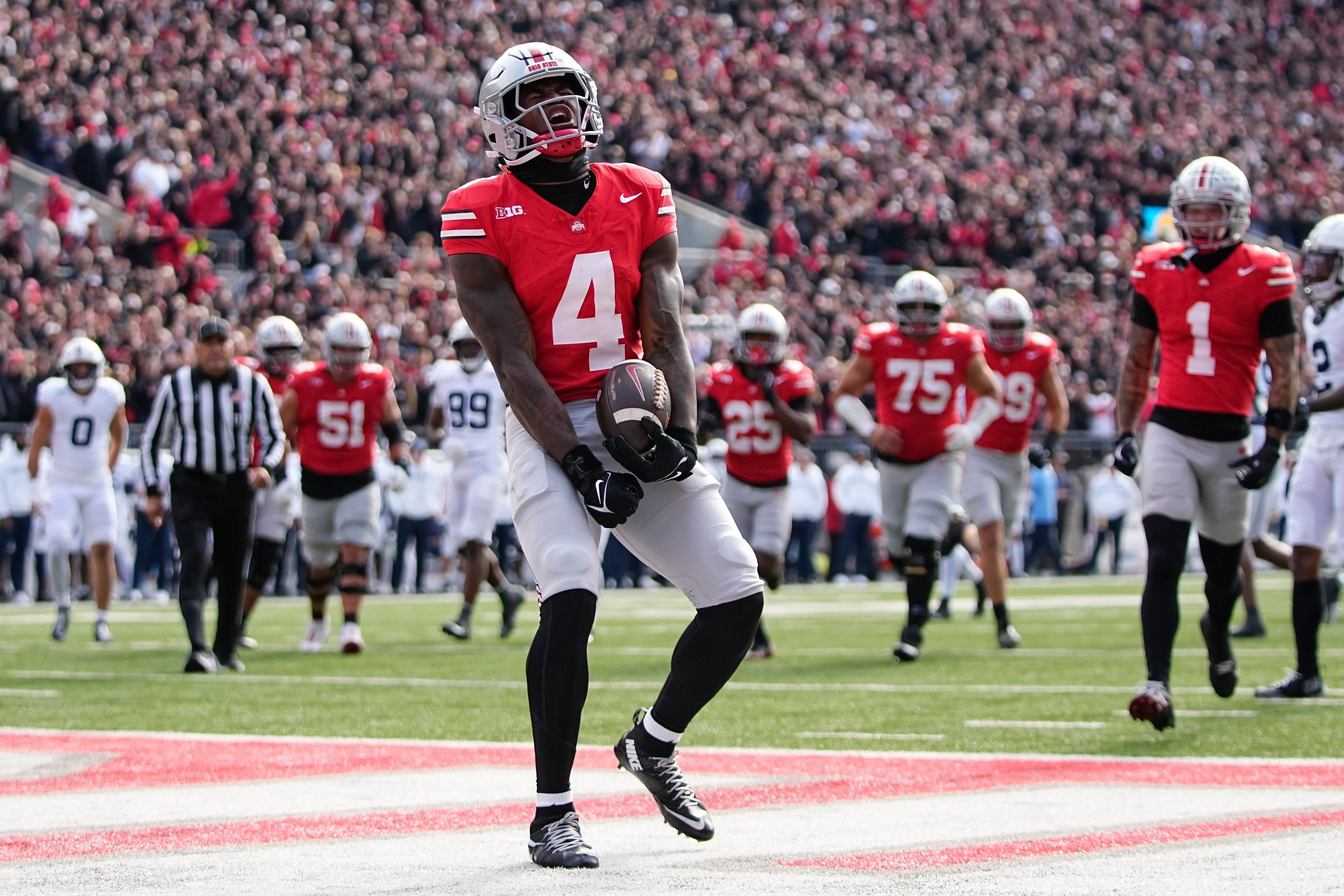 Ohio State receiver Jeremiah Smith celebrates a touchdown as he is featured in our Ohio State vs. Texas touchdown pick.