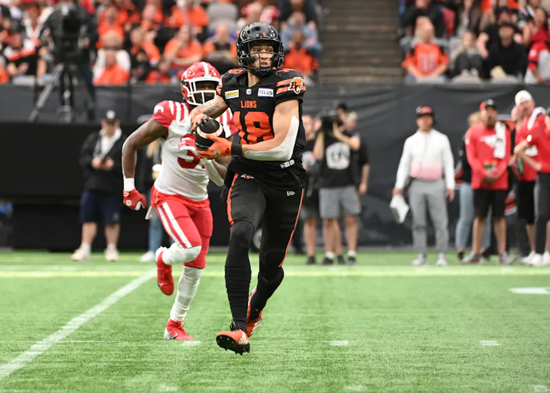 BC Lions wide receiver Justin McInnis makes a catch against the Calgary Stampeders. We expect McInnis to have a big game in our Tiger-Cats vs. Lions prediction.