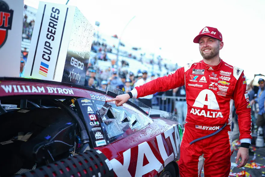William Byron, driver of the #24 Axalta Ruby Chevrolet, places the winner sticker on his car as we look at the NASCAR Cup Series Championship odds ahead of the AutoTrader EchoPark Automotive 400 at Texas Motor Speedway in Fort Worth, Texas.