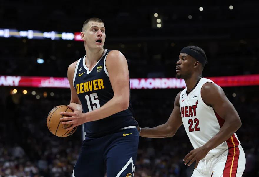 Jimmy Butler of the Miami Heat defends against Nikola Jokic of the Denver Nuggets as we make our Heat vs. Nuggets NBA player props picks and predictions.