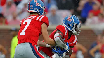 Luke Altmyer of the Ole Miss Rebels hands Zach Evans the ball against the Central Arkansas Bears at Vaught-Hemingway Stadium in Oxford, Mississippi.  Photo by Justin Ford/Getty Images via AFP.