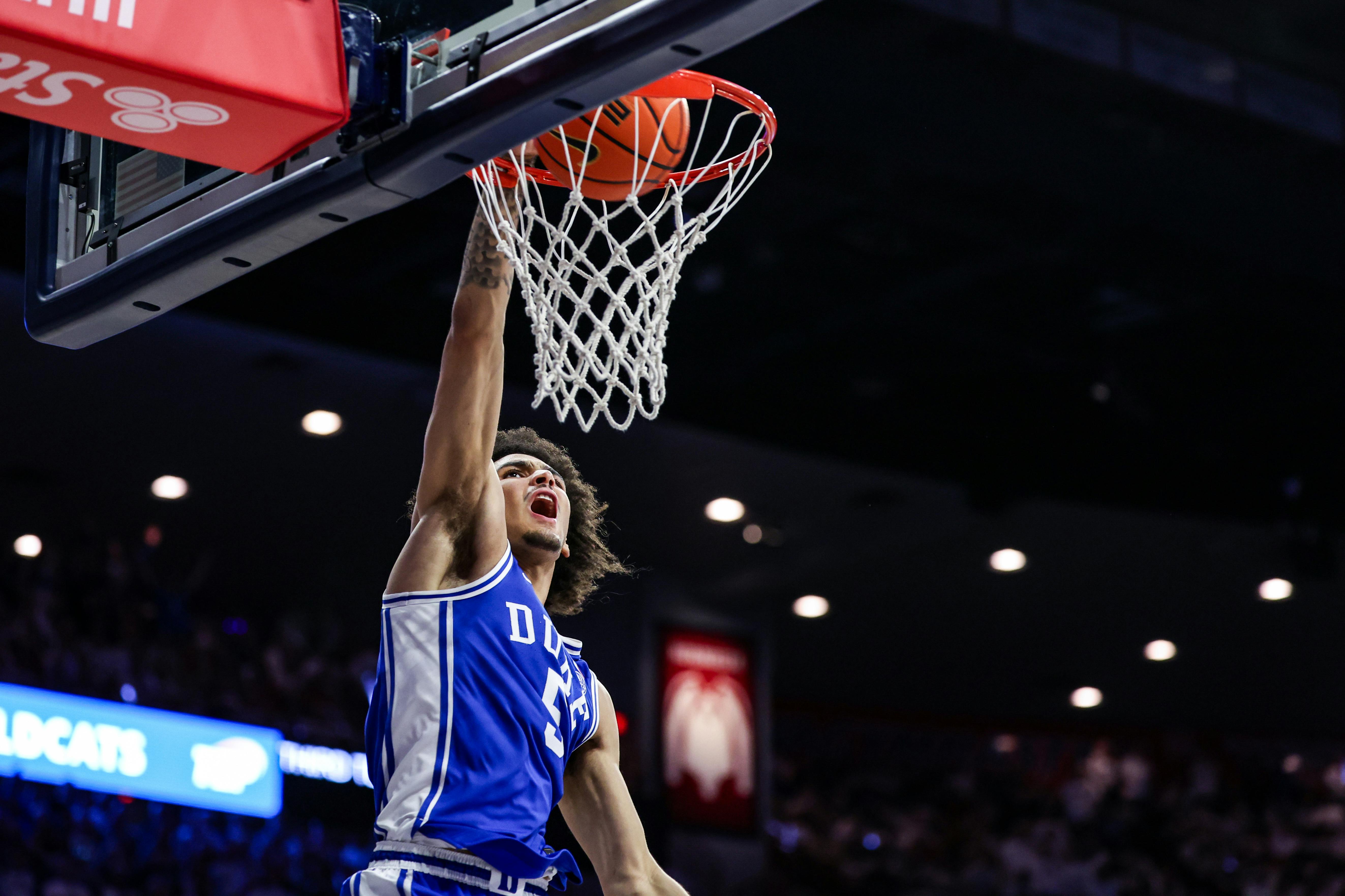 Duke guard Tyrese Proctor dunks the ball against Arizona. The Blue Devils lead the March Madness odds.