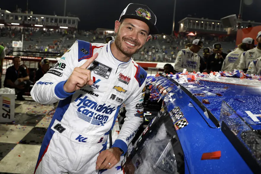 Kyle Larson poses next to his winner sticker in victory lane after winning the NASCAR Cup Series All-Star Race as we make our Coca-Cola 600 picks..