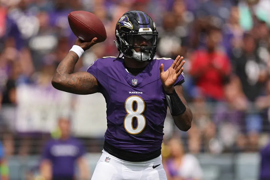 Lamar Jackson of the Baltimore Ravens passes against the Houston Texans, as we share our favorite Joe Burrow vs. Lamar Jackson picks.