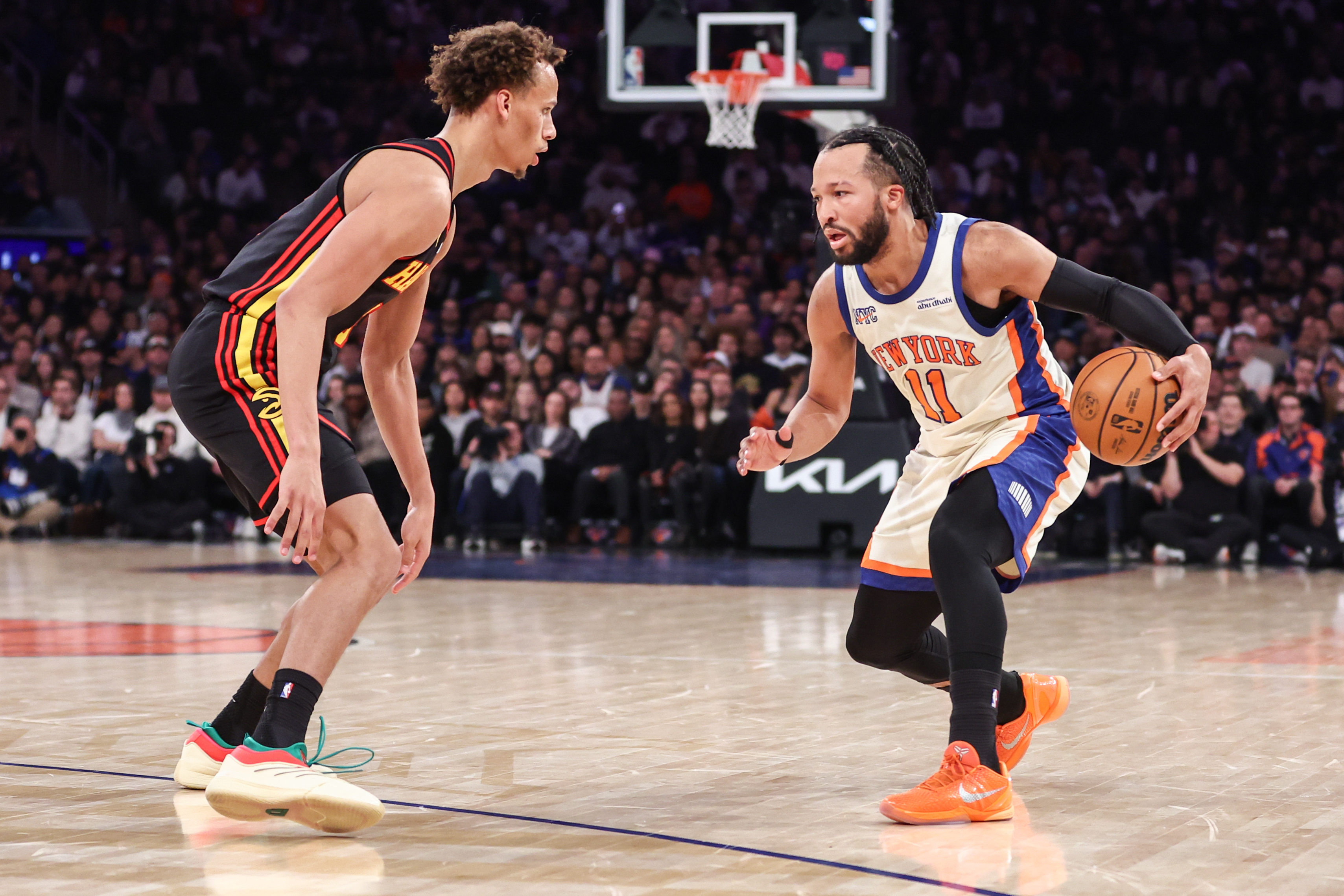 New York Knicks guard Jalen Brunson (11) looks to drive past Atlanta Hawks guard Dyson Daniels (5) as we break down our Hawks vs. Knicks Game 1 player props.
