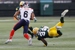 Edmonton Elks defensive back Leon O'Neal Jr. dives to tackle Montreal Alouettes wide receiver Tyson Philpot during the second half at Commonwealth Stadium. Montreal leads the 2024 Grey Cup Odds. 