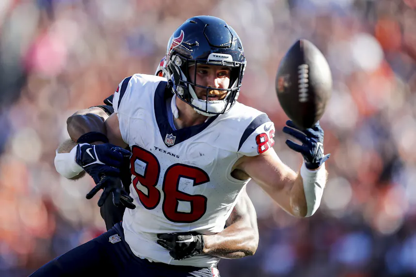 Houston Texans tight end Dalton Schultz attempts to catch a pass against Cincinnati Bengals safety Dax Hill as we look at our Texans vs. Chiefs parlay picks.