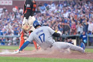 Los Angeles Dodgers DH Shohei Ohtani slides into home plate during the eleventh inning against the San Francisco Giants at Oracle Park. We're backing Ohtani in our MLB Player Props & Expert Picks. 