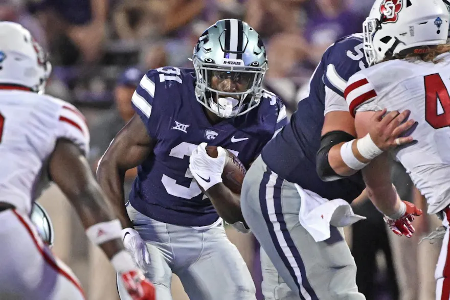 Running back DJ Giddens of the Kansas State Wildcats runs upfield against the South Dakota Coyotes during the second half as we look at our Kansas State-Oklahoma State prediction.