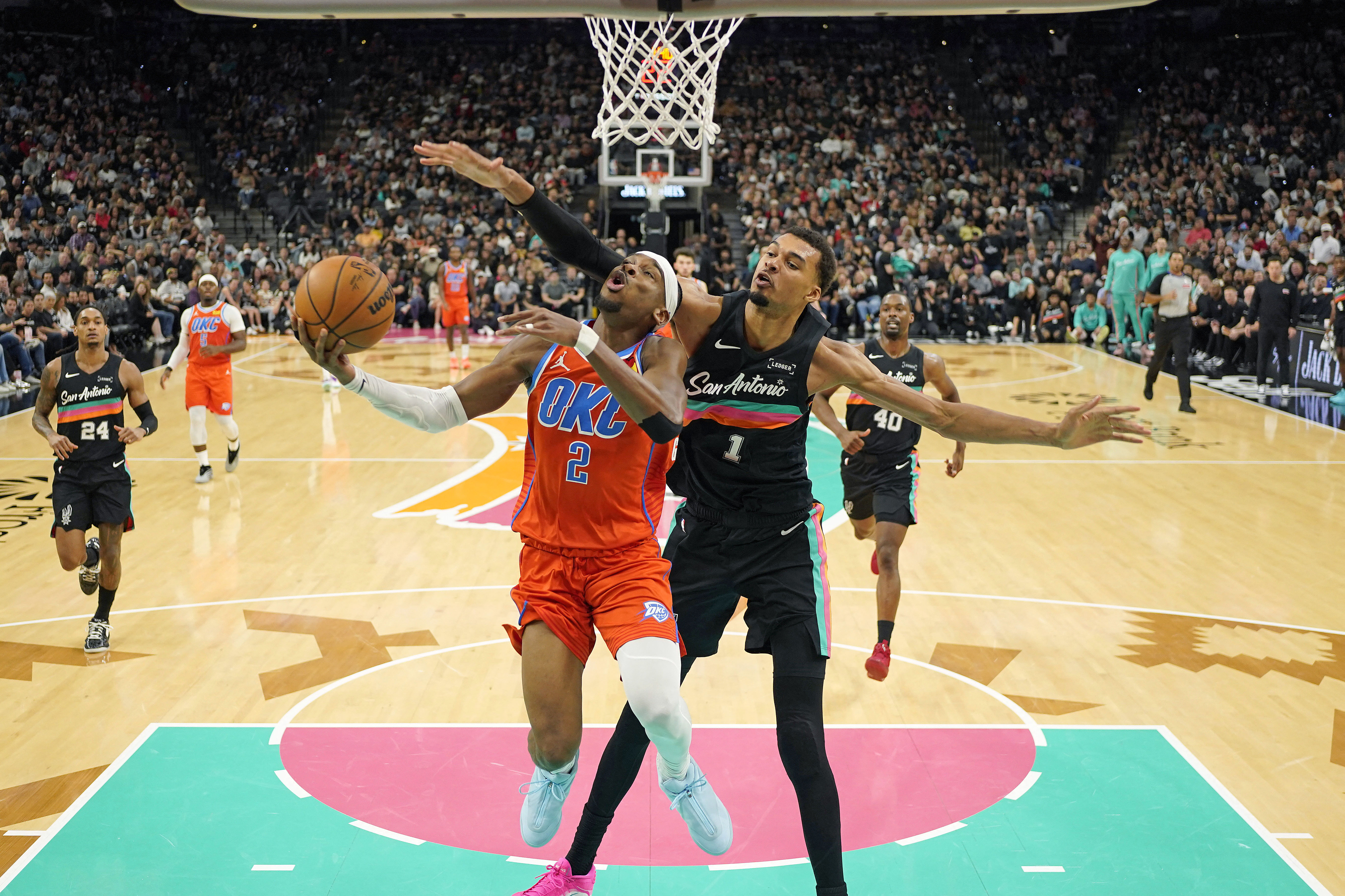 Oklahoma City Thunder guard Shai Gilgeous-Alexander (2) drives to the basket past San Antonio Spurs forward Victor Wembanyama (1), and both will likely be favored in the 2027 NBA Finals MVP odds.