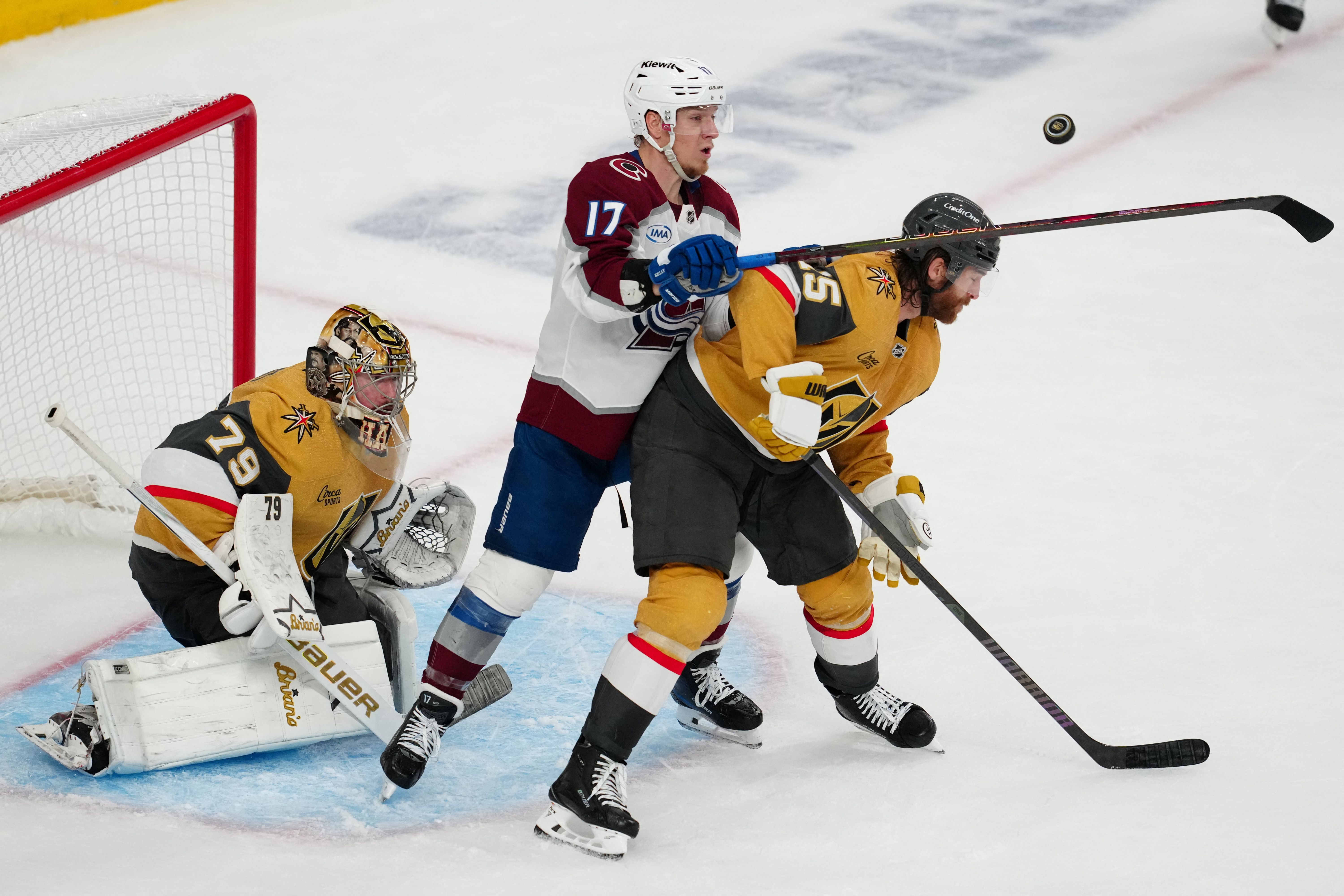 Golden Knights defenseman Noah Hanifin and goaltender Carter Hart defend against Colorado Avalanche center Parker Kelly as we make our best Avalanche vs. Golden Knights predictions. 