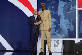 Alexandre Sarr poses for photos with NBA commissioner Adam Silver after being selected in the first round by the Washington Wizards in the 2024 NBA Draft. Sarr leads the NBA Rookie of the Year Odds.