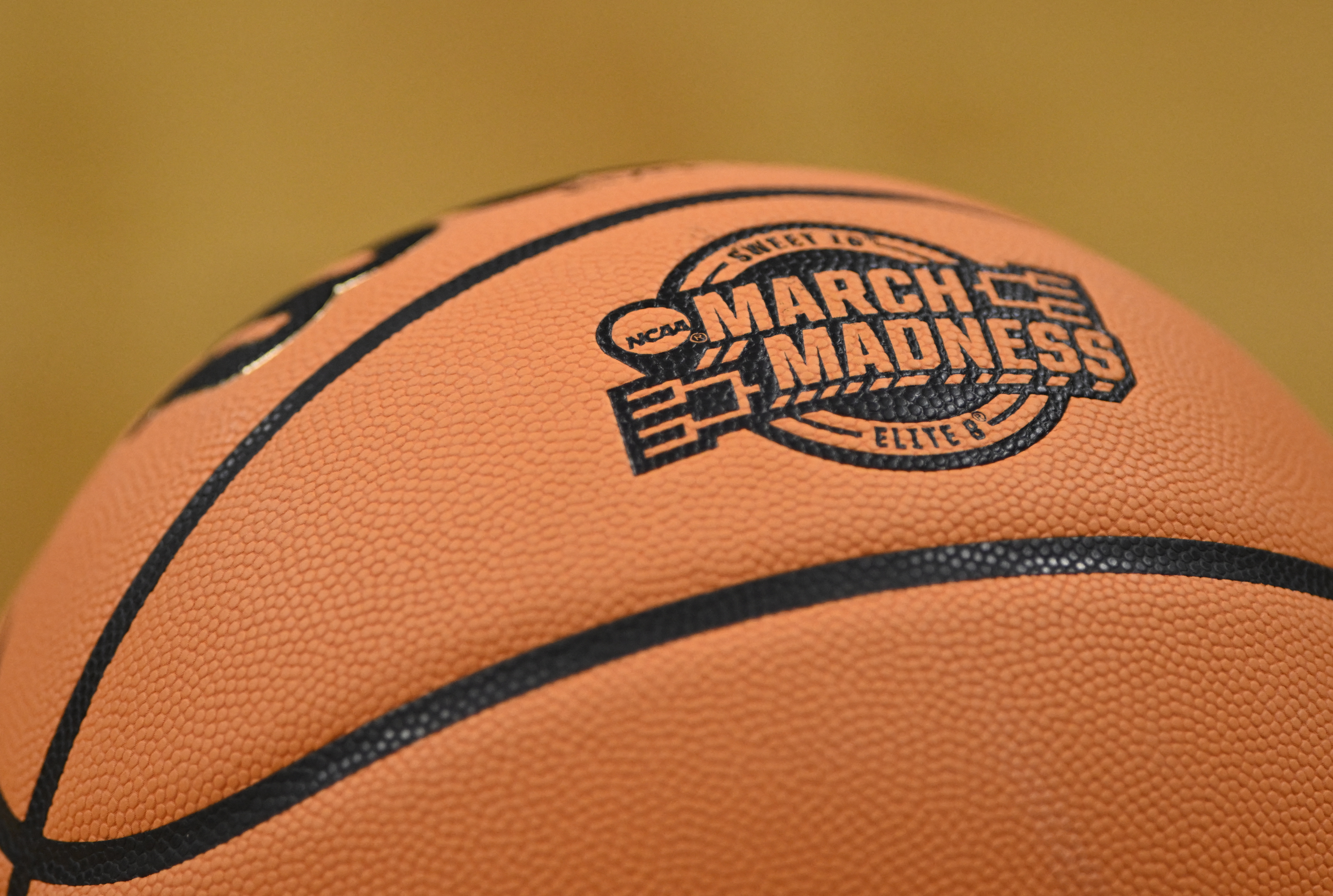 The March Madness logo is seen on a basketball as we look at a judge denying the NCAA's effort to stop DraftKings from using trademarked terms.