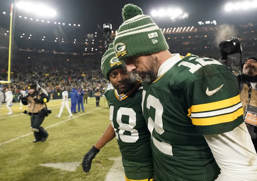 Aaron Rodgers #12 and Randall Cobb #18 of the Green Bay Packers walk off the field after losing to the Detroit Lions at Lambeau Field on Jan. 8.