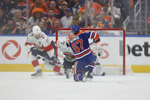 Edmonton Oilers center Connor McDavid shoots the puck defended by Florida Panthers center Eetu Luostarinen as we dive into the best props for Saturday's Game 4 of the Stanley Cup Final between the Panthers and Oilers. 