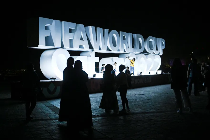 People take photos of the FIFA World Cup sign in Doha on November 16, 2022, ahead of the Qatar 2022 World Cup football tournament.