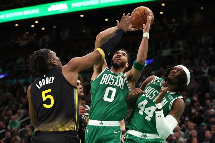 Jayson Tatum of the Boston Celtics takes a shot against Kevon Looney of the Golden State Warriors at TD Garden on Jan. 19, 2023 in Boston, Massachusetts.